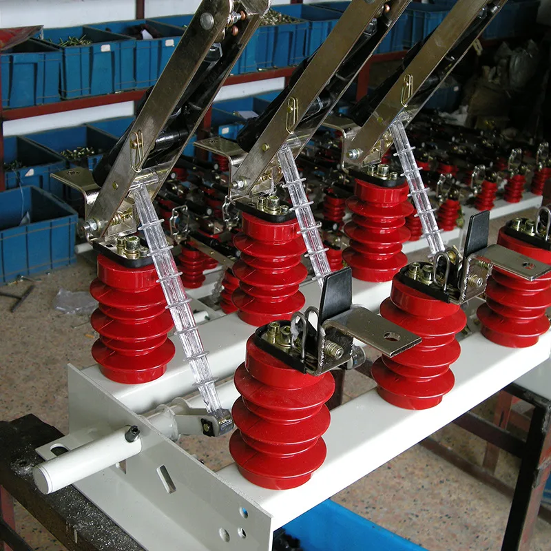 Row of brown porcelain standoff insulators mounted inside switchgear